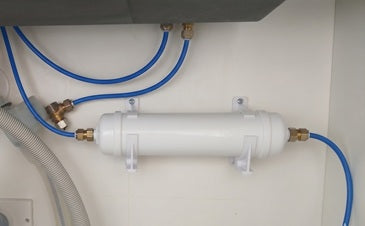 underbench inline filters instal;led in a cupboard