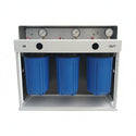 Three blue cylindrical filters with pressure gauges on a white stand against a gray wall.