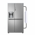 A stainless steel side-by-side refrigerator with a water and ice dispenser on the left door, shown against a plain white background with a white cylindrical filter and black tubing attached on the right side.