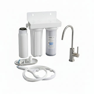 Water filtration system on a kitchen counter with a glass of water and cleaning brush.