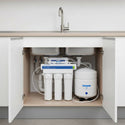 Under-sink water filtration system installed in a kitchen cabinet.